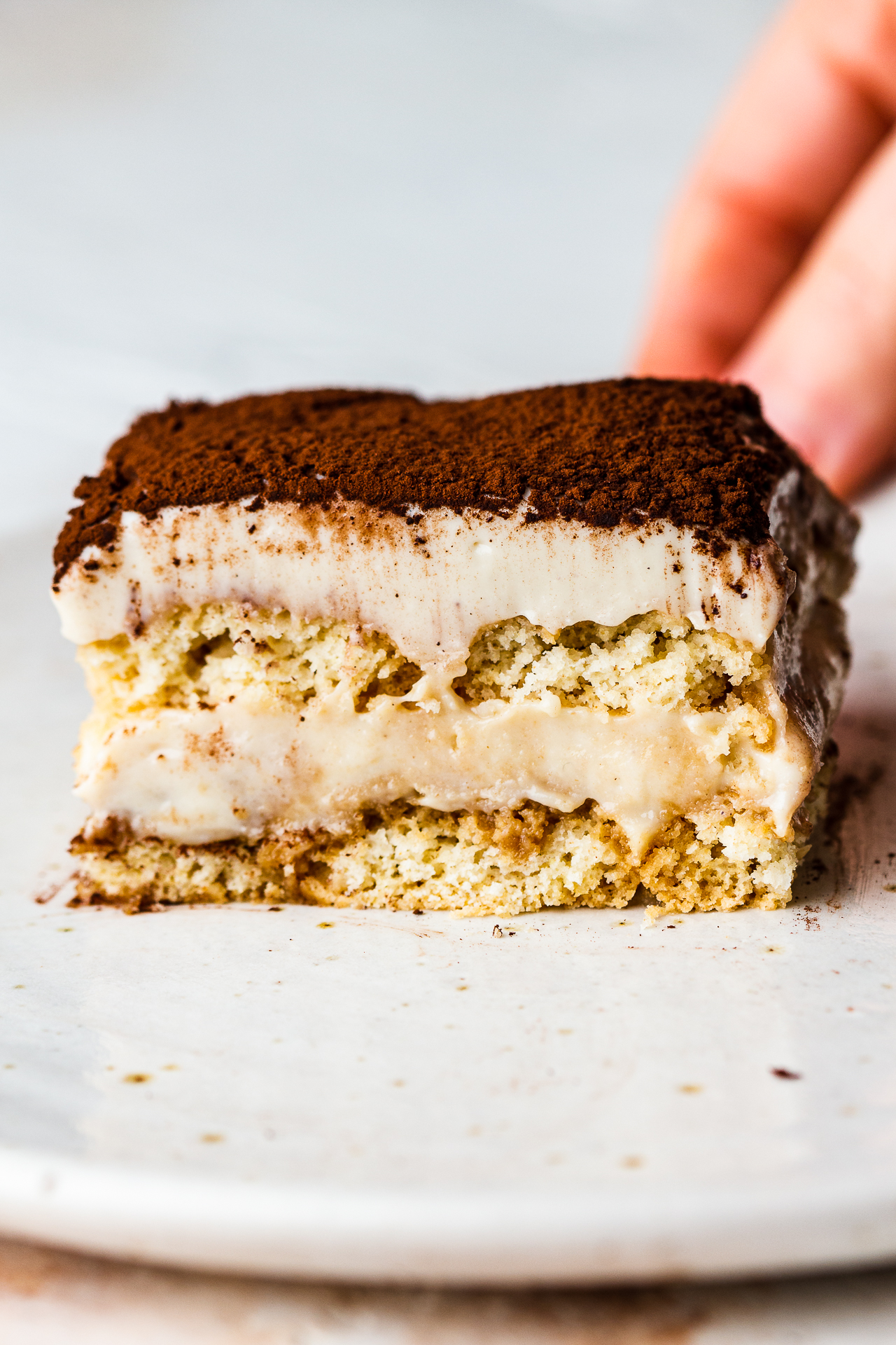 https://www.lazycatkitchen.com/wp-content/uploads/2021/11/vegan-tiramisu-slice.jpg